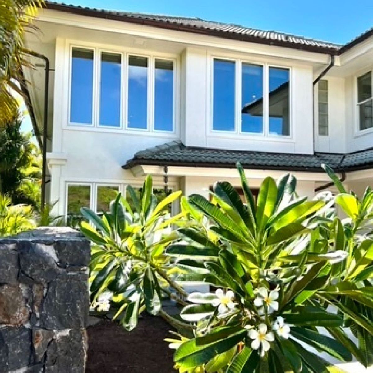 Two-story Maui home exterior with tropical landscaping