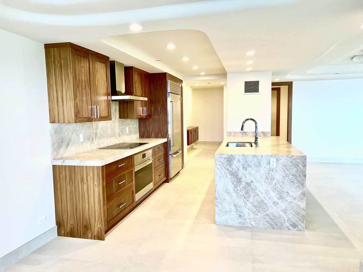 Walnut kitchen with a stone waterfall island