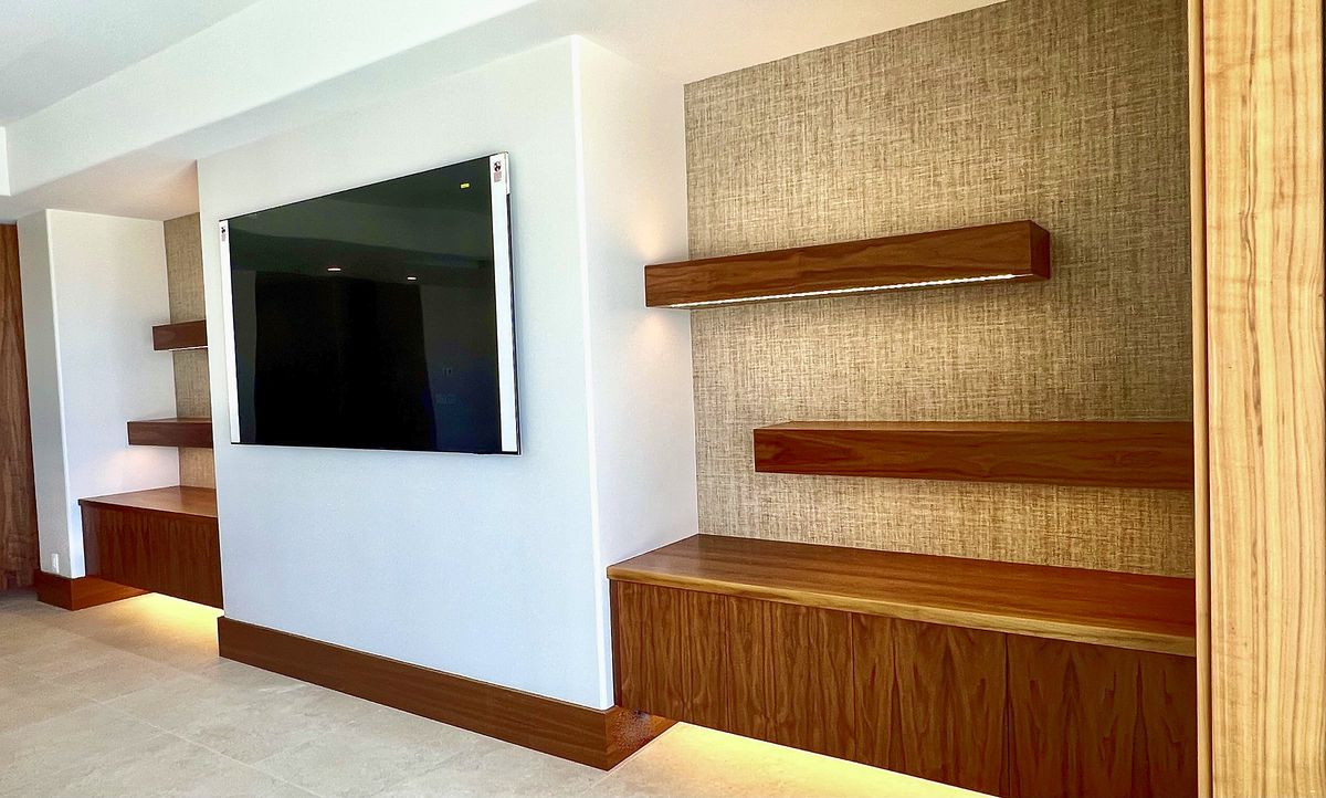 Media wall with floating walnut shelves and LED lighting